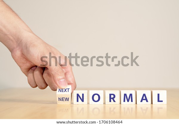 Man's hand with concept of new or next normal digital transform in industry business, disrupt from coronavirus, covid crisis impact to small business or SME. Turn to next normal in financial concept.