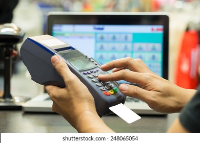 Man's Hand With Credit Card Swipe Through Terminal For Sale In Store