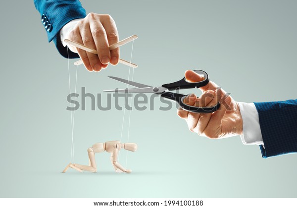 A man\'s hand cuts the threads between the\
puppeteer and the puppet with scissors. The concept of liberation\
from slavery, freedom, shadow government, world conspiracy,\
manipulation, control