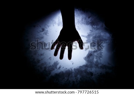 A man's hand in the dark. Supernatural situation. Abstract background for horror with magic.