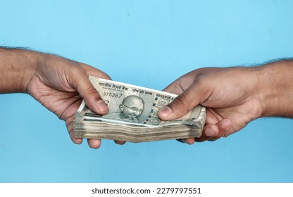 Man's Hand Giving Indian 500 Rupee Bank Notes. concept for earnings or spend in Agriculture. - Powered by Shutterstock