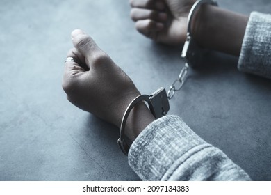 man's hand with handcuff on black background. - Shutterstock ID 2097134383