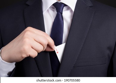 Mans Hand Hiding Ace Card In Business Suit Pocket
