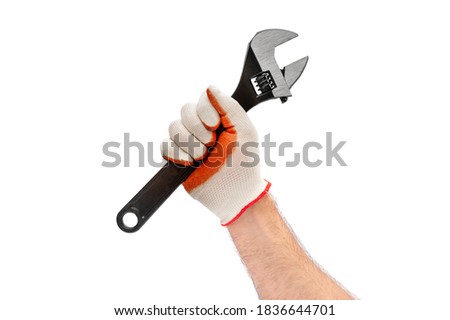 Man's hand holding adjustable wrench. Isolated on white.