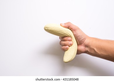 man's hand holding a banana like a big penis that symbolizes erection and potency