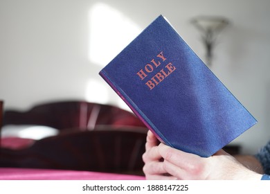 Man's Hand Holding A Bible