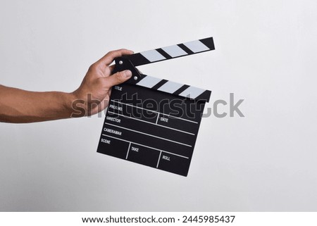 man's hand holding a Clapper board isolated on white background