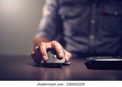 Man's Hand Holding Computer Optical Mouse.