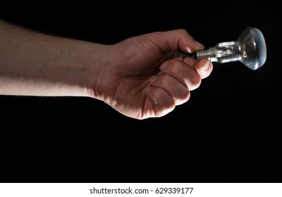 Man's hand holding electrical lamp - Shutterstock ID 629339177