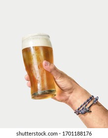 Man's Hand Holding Glass Of Beer Up High On White Background
