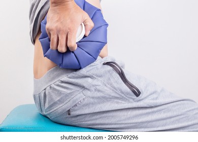 Man's Hand Holding Ice Pack Bag To Compresses On The Back And Waist To Reduce Pain, Swelling. Side View