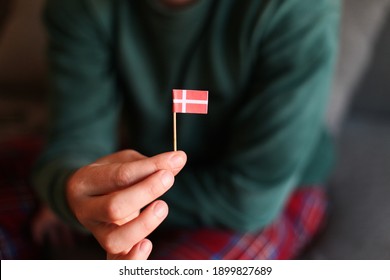 Man's Hand Holding A Little Danish Flag