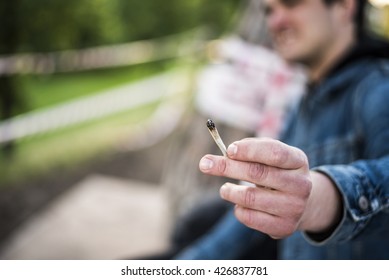 Mans Hand Holding A Marijuana Joint