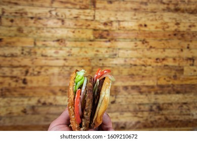 Man's Hand, Holding Onto A Burger
