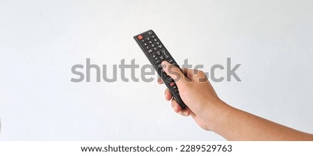 Man's Hand holding remote control isolated on white background with copy space