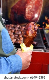 A Man's Hand Holding A Roasted Turkey Leg