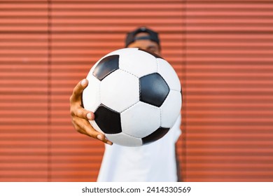 Man's hand holding soccer- close-up - Powered by Shutterstock