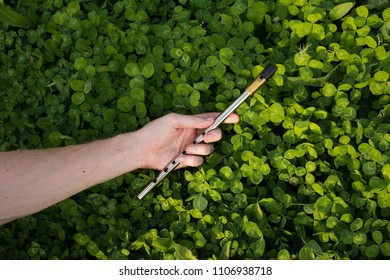 Man's Hand Holding Tin Whistle