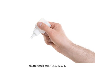 Man's Hand Holding A White Bottle Of Glue Isolated On White Background