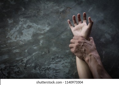man's hand holding a woman hand,  sexual abuse and rape concept, anti-trafficking and stopping violence against women,