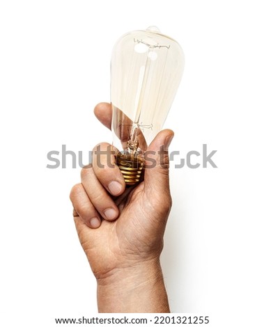 Man's hand holds edison light bulb isolated on white background