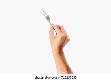 A Man's Hand Holds A Fork On A White Background, Isolate.