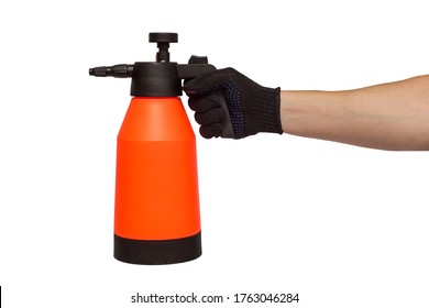 A man's hand holds hand-pumped sprayer isolated on white background. Garden pressure sprayer for dispensing fertilizer, pesticide or herbicide. Garden accesories.