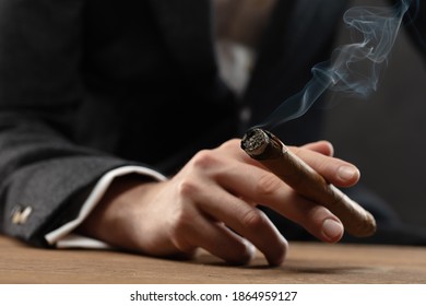 The Man'S Hand Holds A Smoking Cigar - Powered by Shutterstock