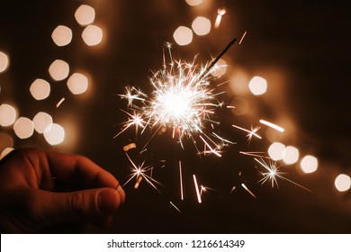 Man's hand holds sparklers, Happy New Year