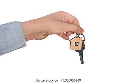 A Man's Hand Isolated On A White Background Dropping A Set Of Keys. Real Estate Transaction. A Man's Hand Holds The Key To The Apartment With A Keychain In The Form Of A House. A Realtor Sells A House