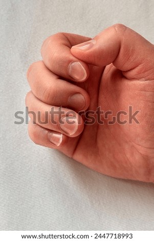 A man's hand with long uncut damaged nails. Unkempt nails of a man on a white background. Close-up