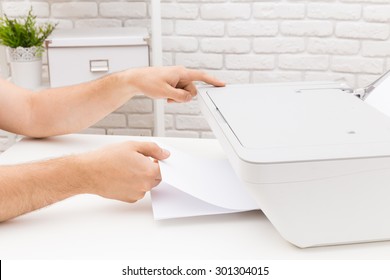 Man's hand making copies. Working with printer