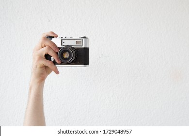 a man's hand with an old camera - Powered by Shutterstock