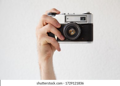 A Man's Hand With An Old Camera