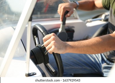 Man's Hand On The Steering Wheel Of A Motor Boat Close Up