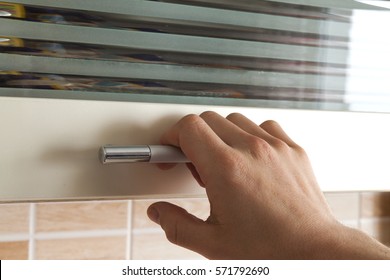 Mans Hand Open The Kitchen Cupboard Doors, Close Up