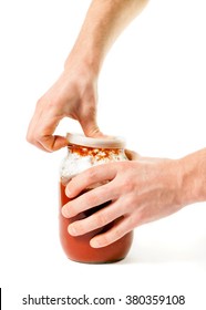 Man's Hand Opening A Glass Jar With Pasta