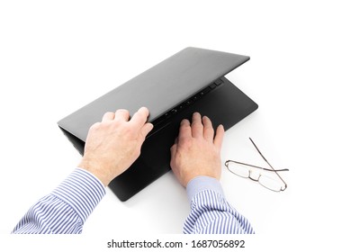 a man's hand opens a notebook computer isolated on white