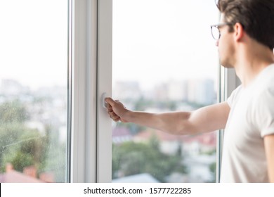 The man's hand opens the window. Ventilating a house in hot weather. - Shutterstock ID 1577722285
