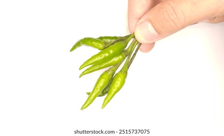 man's hand pinching green chili pepper stalk. isolated white background. - Powered by Shutterstock