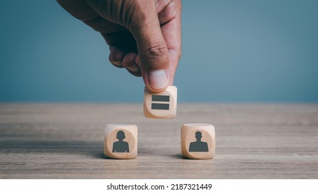 Man's hand is placing wooden blocks on the table, gender equality concepts, human discrimination, liberties and gender issues, reducing social inequality.