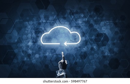 Mans hand pointing to light cloud on dark background