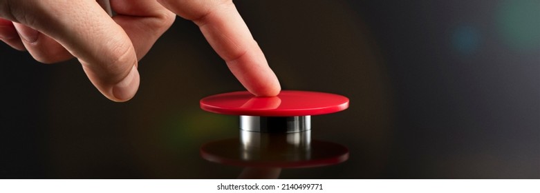 A man's hand presses a big red button. Red button on a dark background. The threat of using nuclear or chemical weapons of mass destruction. Rocket launch at the push of a button
