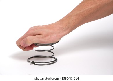 A man's hand presses on a spring, on a white background.Exert pressure - Shutterstock ID 1593404614