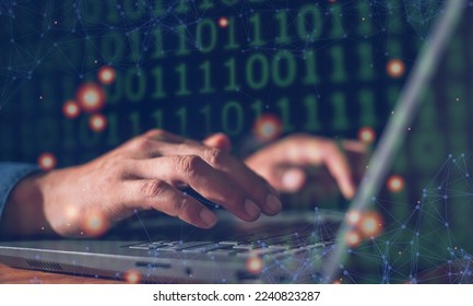 Man's hand programmer using his computer laptop to type binary code of development website in company. Software developer working on digital network connection of internet.