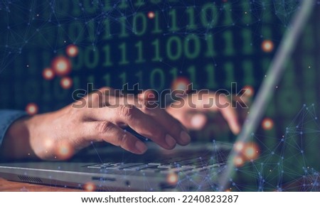 Man's hand programmer using his computer laptop to type binary code of development website in company. Software developer working on digital network connection of internet.