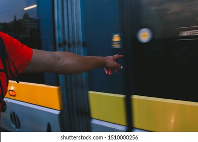 man's hand pushing the button on the train in motion 