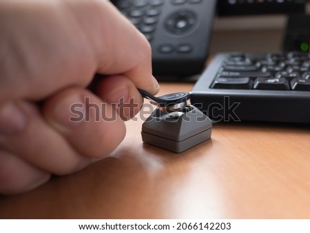 a man's hand puts a touch memory key on the reader to access the computer. the concept of cybersecurity and access restrictions. copy space.