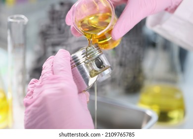 Mans Hand In Rubber Gloves Holding Car Part And Pours Lubricating Oil On It