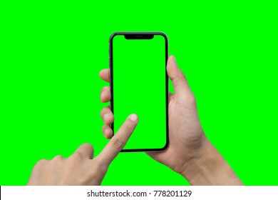 Man's hand shows mobile smartphone with green screen in vertical position isolated on green background - Powered by Shutterstock